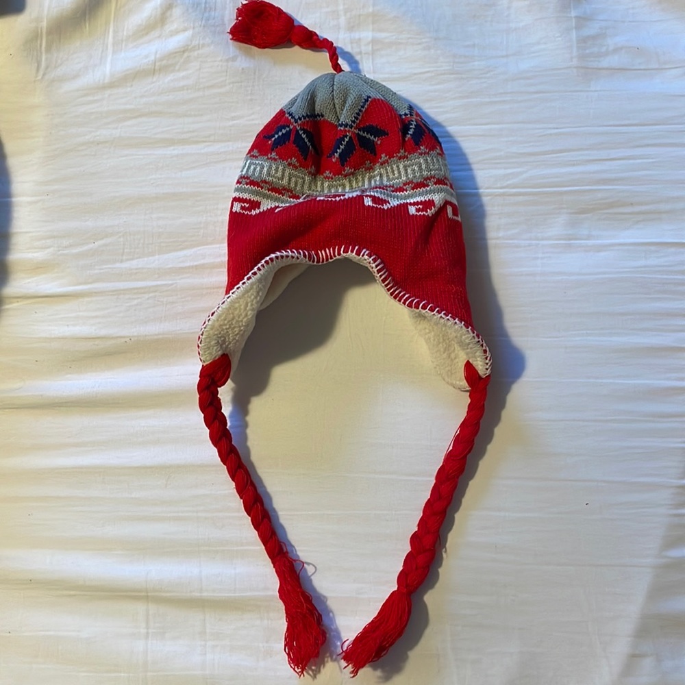 Children’s winter hat with tassel and “braids”